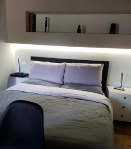 a bedroom with a large bed with two lamps on it at Contemporary Rooms in San Gimignano