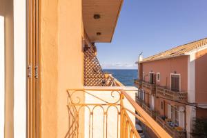 an apartment balcony with a view of the ocean at Yria Hotel in Zakynthos