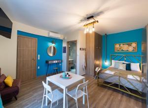 a bedroom with blue walls and a bed and a table at Casa De Blue in Kariá