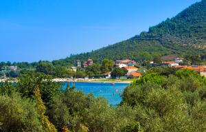 a view of a lake with people swimming in it at Aegean Sun Hotel in Skala Rachoniou