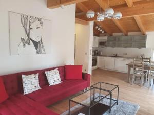 a living room with a red couch and a table at Eldenhof in Plau am See
