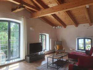 a living room with a couch and a tv at Eldenhof in Plau am See