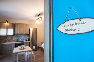 a sign that says once we blue shinks in a kitchen at Casa De Blue in Kariá