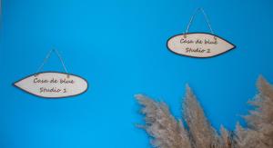 a sign that reads cause the rules struggle with a plant at Casa De Blue in Kariá