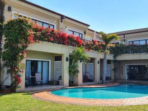 a house with a swimming pool in the yard at Fairway Guest House in Durban