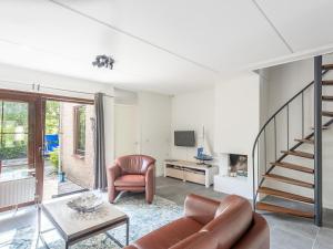 a living room with a couch and a chair at Spaanse Galeien 106 in Retranchement