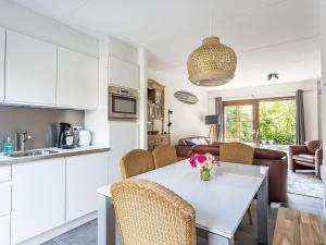 a kitchen and living room with a table and chairs at Spaanse Galeien 106 in Retranchement