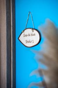 a sign that reads cause be twice studying at Casa De Blue in Kariá