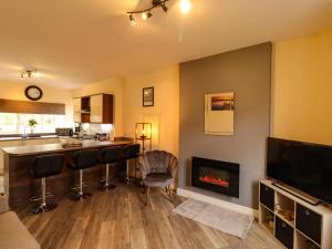 a living room with a bar and a fireplace at River View 2 Bridge Street in Cockermouth