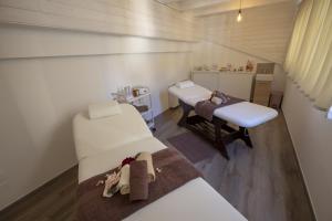 a hospital room with two beds and a table at Luxmarì Hotel & Spa in Castellammare del Golfo