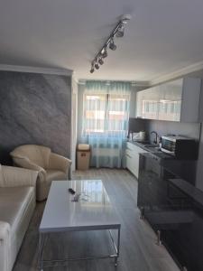 a living room with a couch and a table at Vila El Passo in Târgu-Mureş