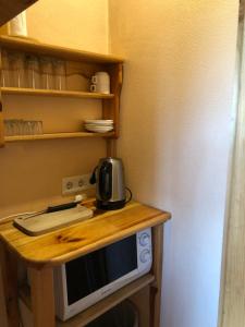 a microwave sitting on top of a wooden table at Brīvdienu mājas Pārupes in Bauska