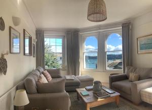 a living room with a couch and a table at The Old Post Office in Salcombe