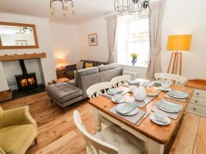 a living room with a table and chairs and a couch at Curlew Cottage, 2 Fenkle Street in Berwick-Upon-Tweed