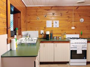 a kitchen with a stove and a sink at Historic cottage 200m from shops and cafes Wifi Netflix included - #142 in Bathurst