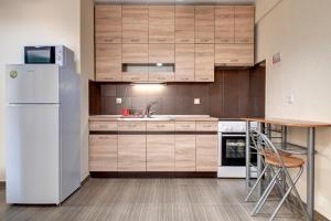 a kitchen with a white refrigerator and a table at Achilleas Apartments in Kalives Poligirou