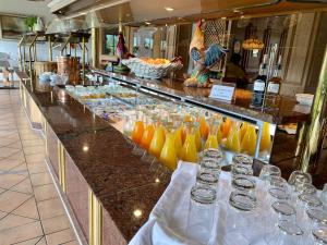 a buffet line with glasses of orange juice at Hotel Bichlhof in Reit im Winkl