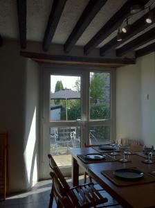 a dining room with a table and a large window at Poet's Cottage in Trefriw