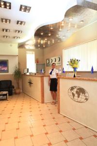 a woman standing at a counter in a lobby at Fort Hotel in Yekaterinburg