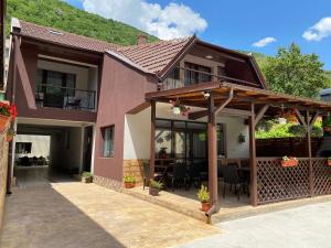 a house with a patio in front of it at Casa Adriana in Băile Herculane