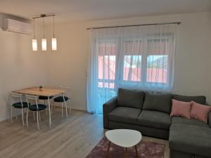a living room with a couch and a table at Éva Apartmanház in Csopak