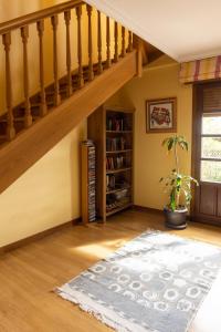 a living room with stairs and a rug at La casa de Epi in Ziordia