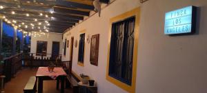 a restaurant with a table and a sign on the wall at Finca Cafetera Los Ángeles in Líbano