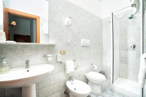 a bathroom with a sink and a toilet and a shower at Hotel Fontana in Amalfi