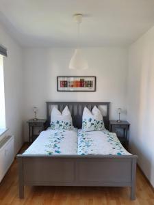 a bed with two pillows on it in a bedroom at Eldenhof in Plau am See
