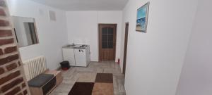 a hallway with a room with white walls and a door at Cazino4Love in Constanţa