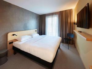 Postel nebo postele na pokoji v ubytování ibis Styles Bayreuth