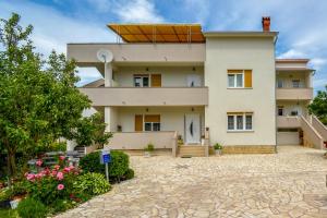 a house with a solarium on top of it at Apartments Angela Rab in Supetarska Draga