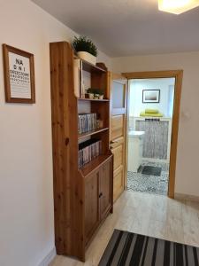 a room with a book shelf and a hallway at Kwatera nad morzem Orłowo in Gdynia