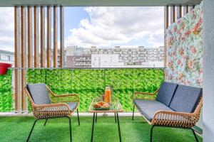 un balcone con due sedie e un tavolo con frutta di T2 LUXE proche PARIS TERRASSE PARKING PRIVE a Vitry-sur-Seine