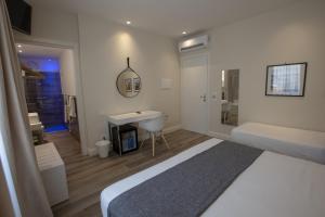 Posteľ alebo postele v izbe v ubytovaní Luxmarì Hotel & Spa