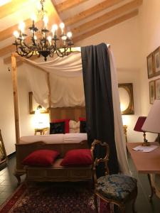 a bedroom with a canopy bed with red pillows at Sanctus Syrus 2 in Albenga