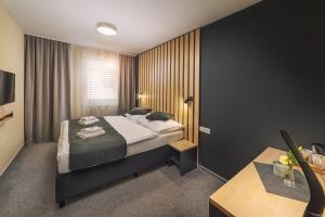 Postel nebo postele na pokoji v ubytování TIMEOUT City Hotel