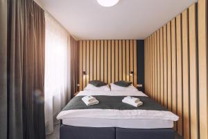 Postel nebo postele na pokoji v ubytování TIMEOUT City Hotel