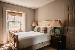 a bedroom with a bed and a window at Shieldaig Lodge Hotel in Gairloch