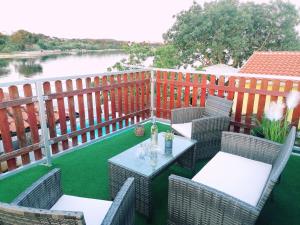 a patio with chairs and a table with a view of a river at Holiday Home Tereza in Medulin