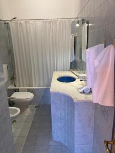 a bathroom with a blue sink and a toilet at Apartamentos Mar-Sol Villas in Vilamoura