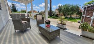 a patio with chairs and a table and potted plants at A Casa Di Coso B&B in Marsala