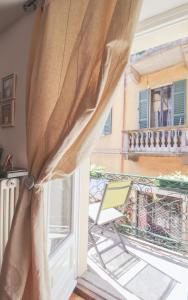 a balcony with a chair and a window at Il Tuffatore in Menaggio