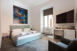 a bedroom with a bed and a flat screen tv at Nikis Collection Navona in Rome