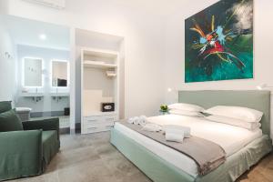 a bedroom with a bed and a painting on the wall at Nikis Collection Navona in Rome