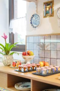a kitchen counter with fruits and jams on a table at Tante ALMA's Bonner Hotel in Bonn