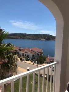 a view of the water from a balcony at Apartamentos El Bergantin Menorca Club in Fornells