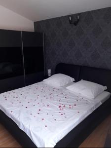 a bed with red hearts on top of it at Apartment Relax in Vir