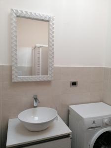 a bathroom with a sink and a washing machine at P in centro in Sestri Levante +16 photos