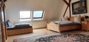 a bedroom with two beds and a rug at Apartmenthaus Am Schlosspark in Schkopau